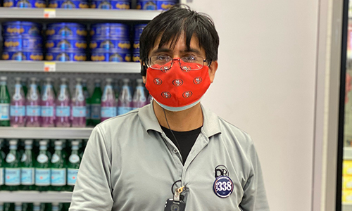 Older Person standing in front of beverages 