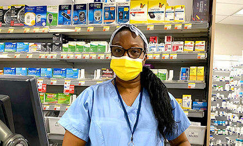 Pharmacy Clerk Member standing in the pharmacy