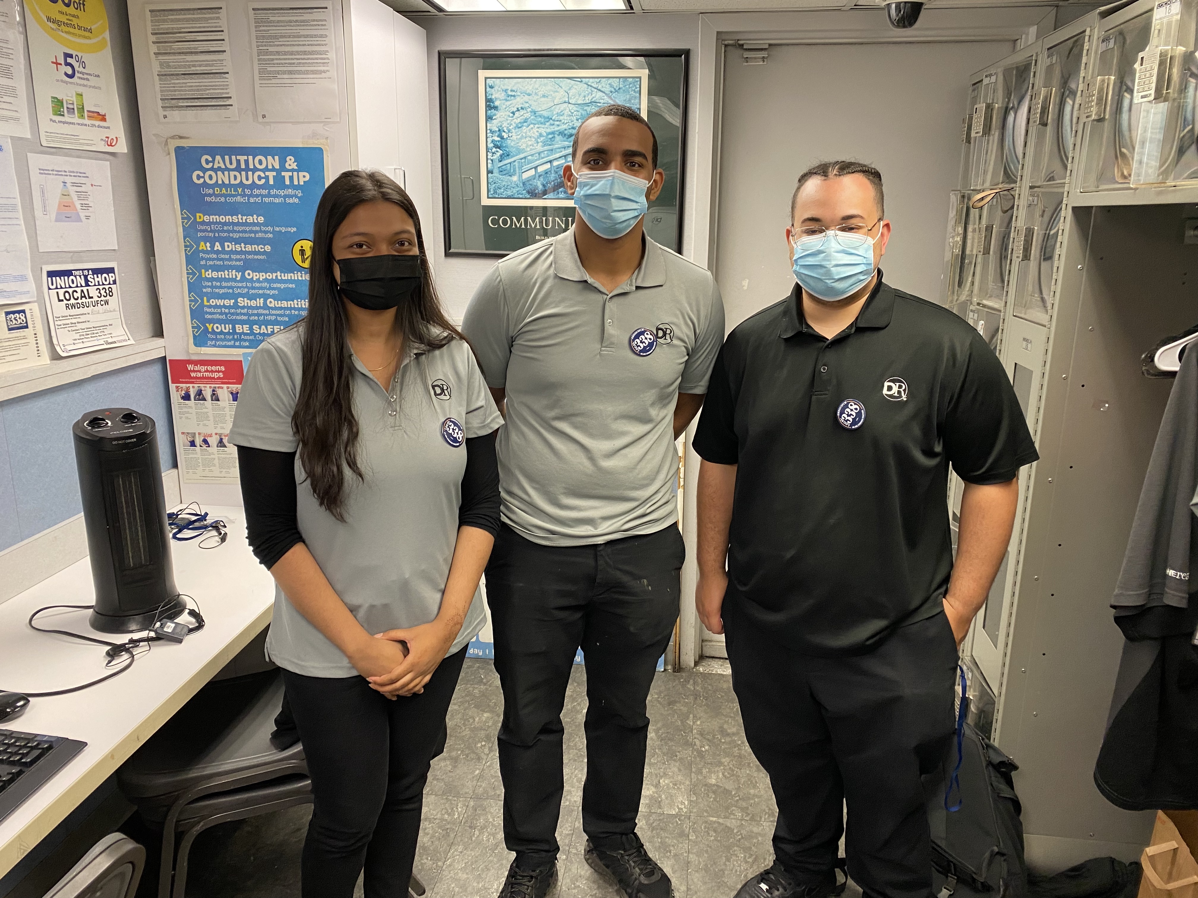 three members standing side by side in an office setting