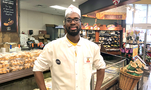 Member standing in front of the bakery department