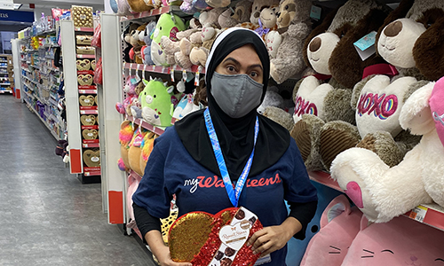Member standing in front of the valentine's day display 