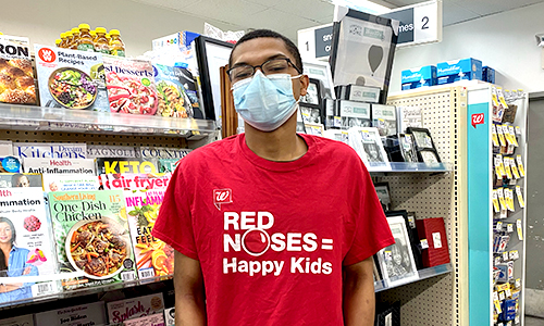 Member Standing in front of magazines